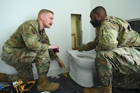 Members of the D.C. Air National Guard’s 113th Wing Civil Engineer Squadron (CES) conduct HVAC diagnostics and repair, LED lighting installation, plumbing fixture placement, and electrical rewiring at the Capital Guardian Youth ChalleNGe Academy (CGYCA), in Laurel, MD, on April 12, 2025. The hands-on April 7-19 project not only offered vital Administrative Building upgrades, but also skills development. Civil engineers maintain the infrastructure for military operations ensuring they’re functional, relevant, efficient, and resilient in various operational environments.