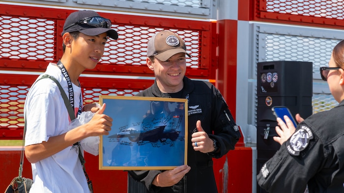 Japanese airshow fan and an Air Force pilot pose for a photo together