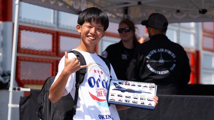 Japanese airshow fan poses for a photograph