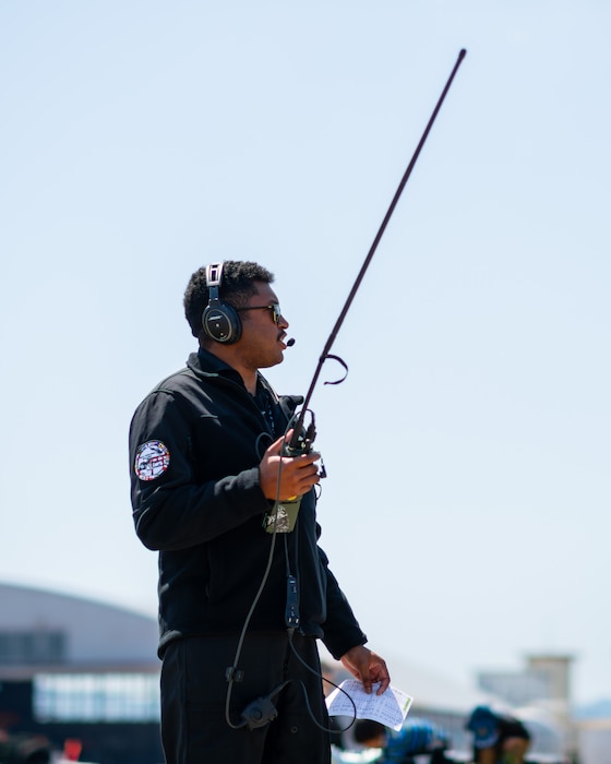 Air Force pilot holds a radio