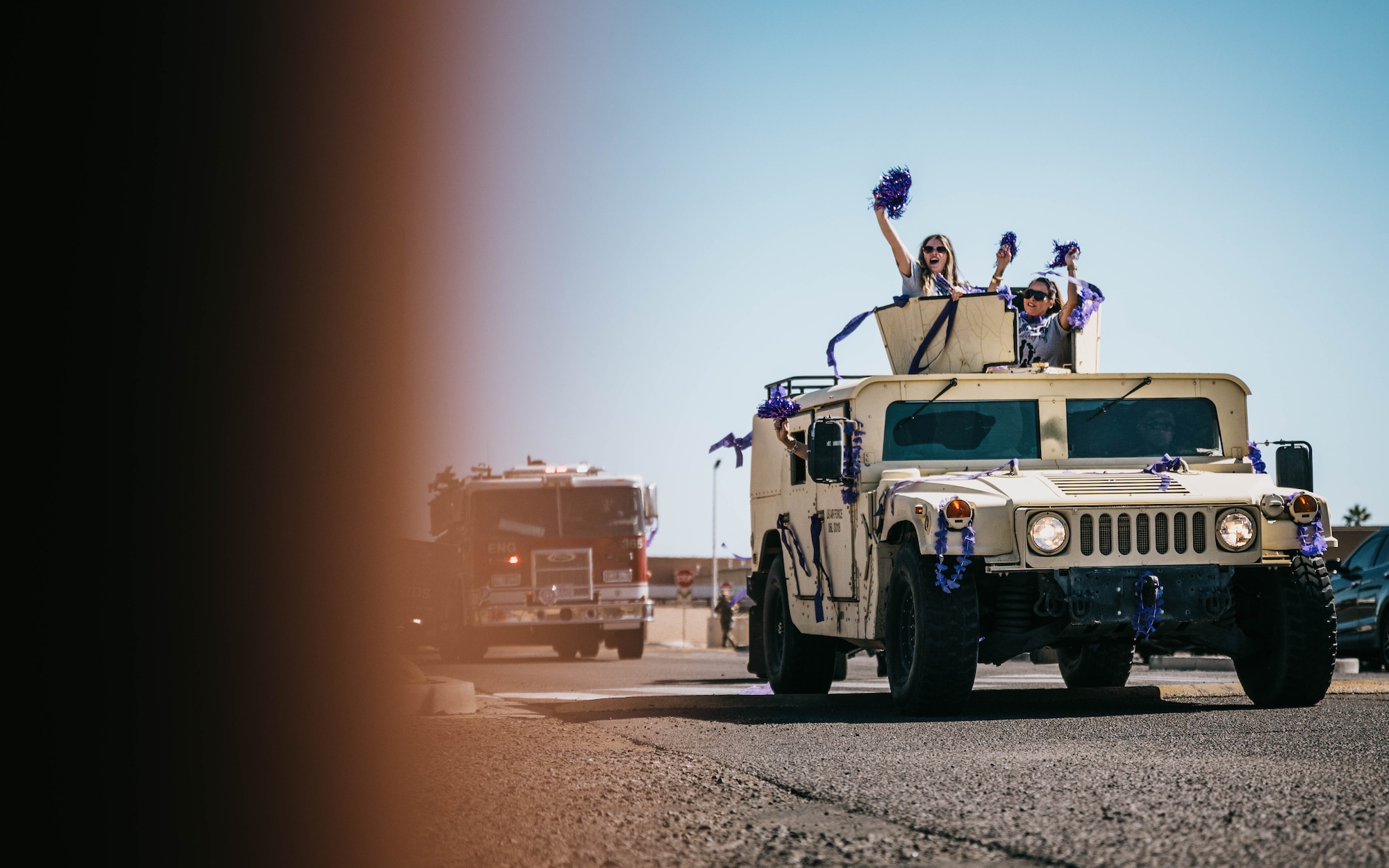 Luke Air Force Base Child Development Center employees ride in a High Mobility Multipurpose Wheeled Vehicle during the Purple Up parade, April 25, 2025, at Luke Air Force Base, Arizona.