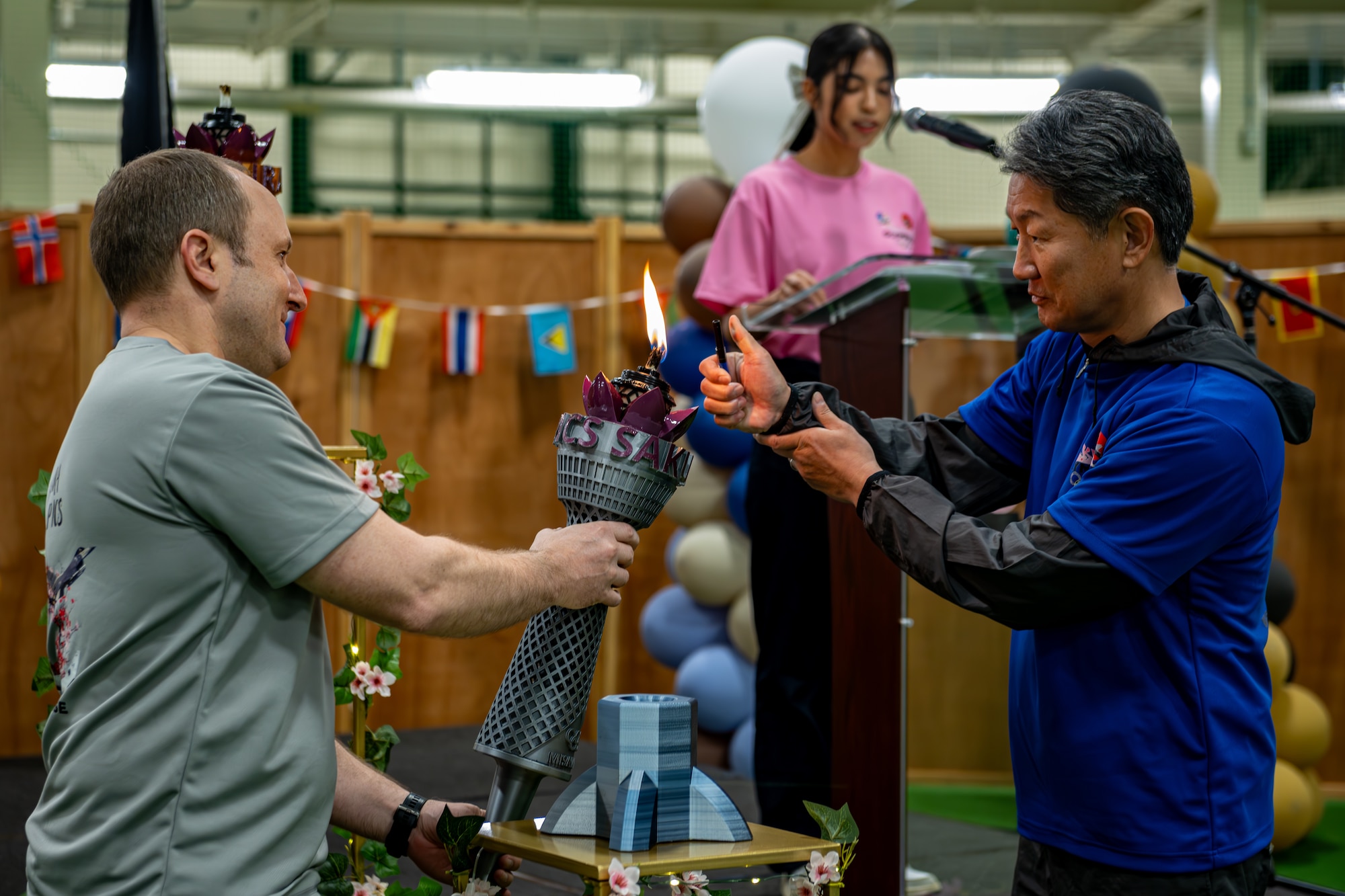 U.S. Air Force and JASDF representatives work together to light a torch.