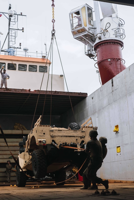 U.S. Marines 3rd Littoral Logistics Battalion, 3rd Marine Littoral Regiment, 3rd Marine Division, assist in offloading a Joint Light Tactical Vehicle from a commercial vessel in Subic Bay, Philippines, June 19, 2024. 3rd LLB conducted the maneuver to test logistical capabilities within the Philippine maritime areas. The training event was part of Marine Aviation Support Activity 24, an annual Philippine-U.S. military exercise focused on mutual defense, strengthening relationships, and rehearsing aviation concepts. (U.S. Marine Corps photo by Sgt. Jacqueline C. Parsons) (Photo edited for security purposes)