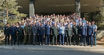 Multinational participants of Pacific Airlift Rally 25 pose for a group photo following the opening ceremony at the Kempinski Hotel in Ulaanbaatar, Mongolia, May 5, 2025.