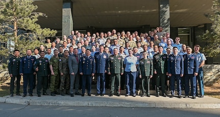 Multinational participants of Pacific Airlift Rally 25 pose for a group photo following the opening ceremony at the Kempinski Hotel in Ulaanbaatar, Mongolia, May 5, 2025.