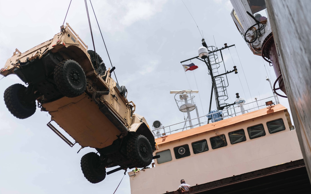 A Joint Light Tactical Vehicle is offloaded from a commercial vessel in Subic Bay, Philippines, June 19, 2024. U.S. Marines 3rd Littoral Logistics Battalion, 3rd Marine Littoral Regiment, 3rd Marine Division, utilized the vessel to test logistical capabilities within the Philippine maritime areas. The training event was part of Marine Aviation Support Activity 24, an annual Philippine-U.S. military exercise focused on mutual defense, strengthening relationships, and rehearsing aviation concepts. (U.S. Marine Corps photo by Sgt. Jacqueline C. Parsons) (Photo edited for security purposes)