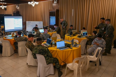 U.S. Marines and Armed Forces of the Philippines service members work in groups during a Cyber Defense Exercise in support of Exercise Balikatan 25 at Camp Aguinaldo, Manila, Philippines, April 24, 2025.