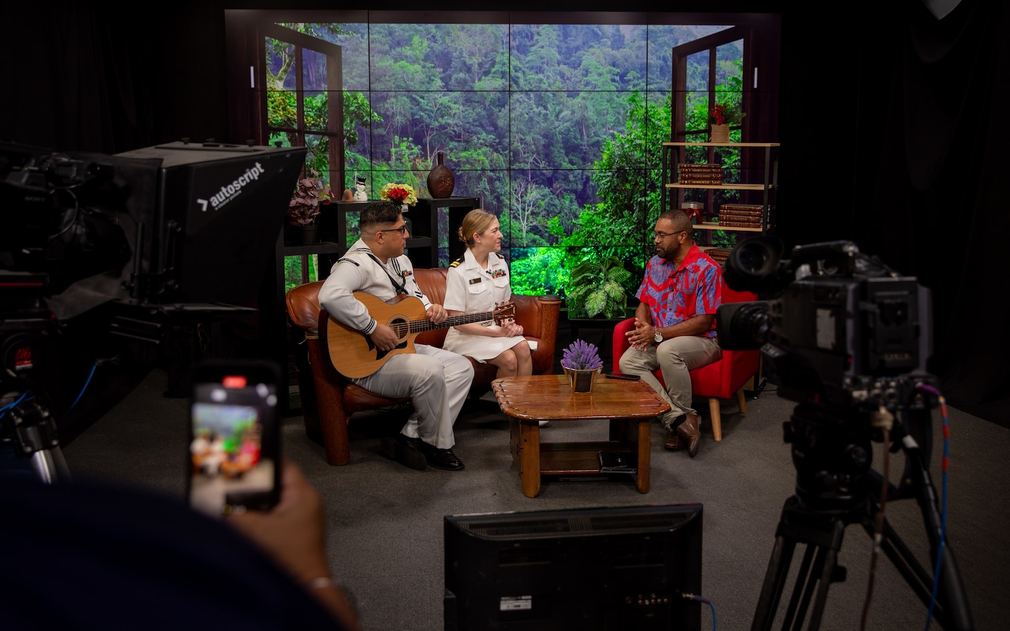 Musician 2nd Class Marcel Carrion, from Washington, D.C., assigned to U.S. 7th Fleet Bands’ “Orient Express,” and Lt. Andrea Sematoske, from Syracuse, New York, bandmaster of the U.S. 7th Fleet Band, both embarked aboard the U.S. 7th Fleet flagship USS Blue Ridge (LCC 19), participate in the “Breakfast Show,” with host Tevita Nawadra Ratabacaca on Fiji TV during a port visit to Suva, Fiji, May 6, 2025. Blue Ridge and the 7th Fleet staff conduct regular Indo-Pacific patrols to deter aggression, strengthen alliances and partnerships, and advance future warfighting capabilities. (U.S. Navy photo by Mass Communication Specialist 1st Class Ryan M. Breeden)