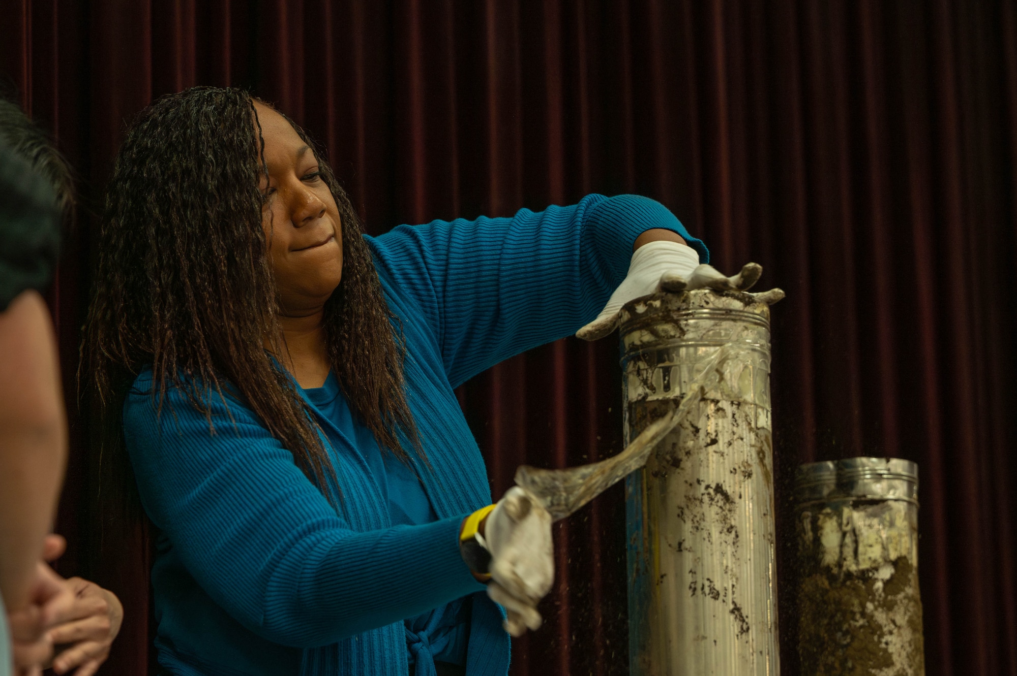 Dr. Kimberly Johnson, Mendel Elementary School assistant principal, opens a 25-year-old time capsule.
