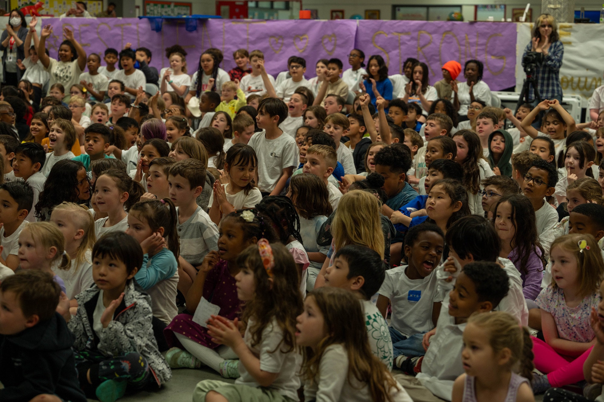 Students from Mendel Elementary School watch staff members and former students open the 25-year-old time capsule.