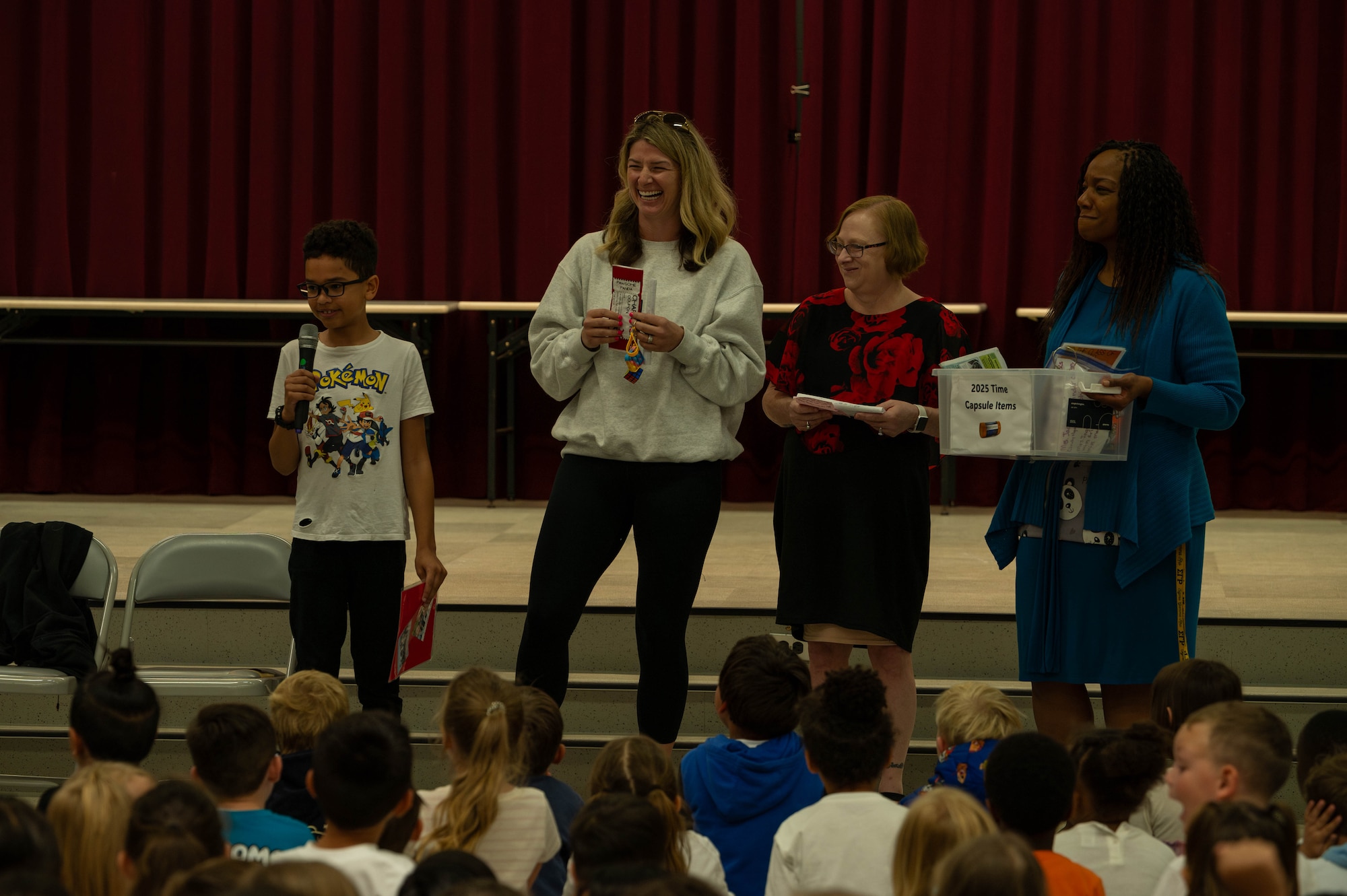 A student from Mendel Elementary School speaks to other students before putting an item into the time capsule.