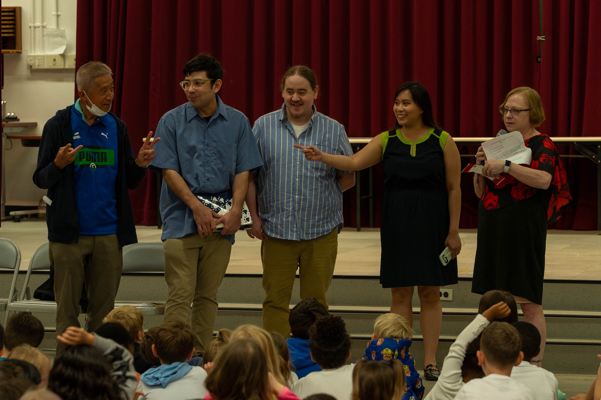 Former students from Mendel Elementary School line up for students during the 25-year-old time capsule opening.