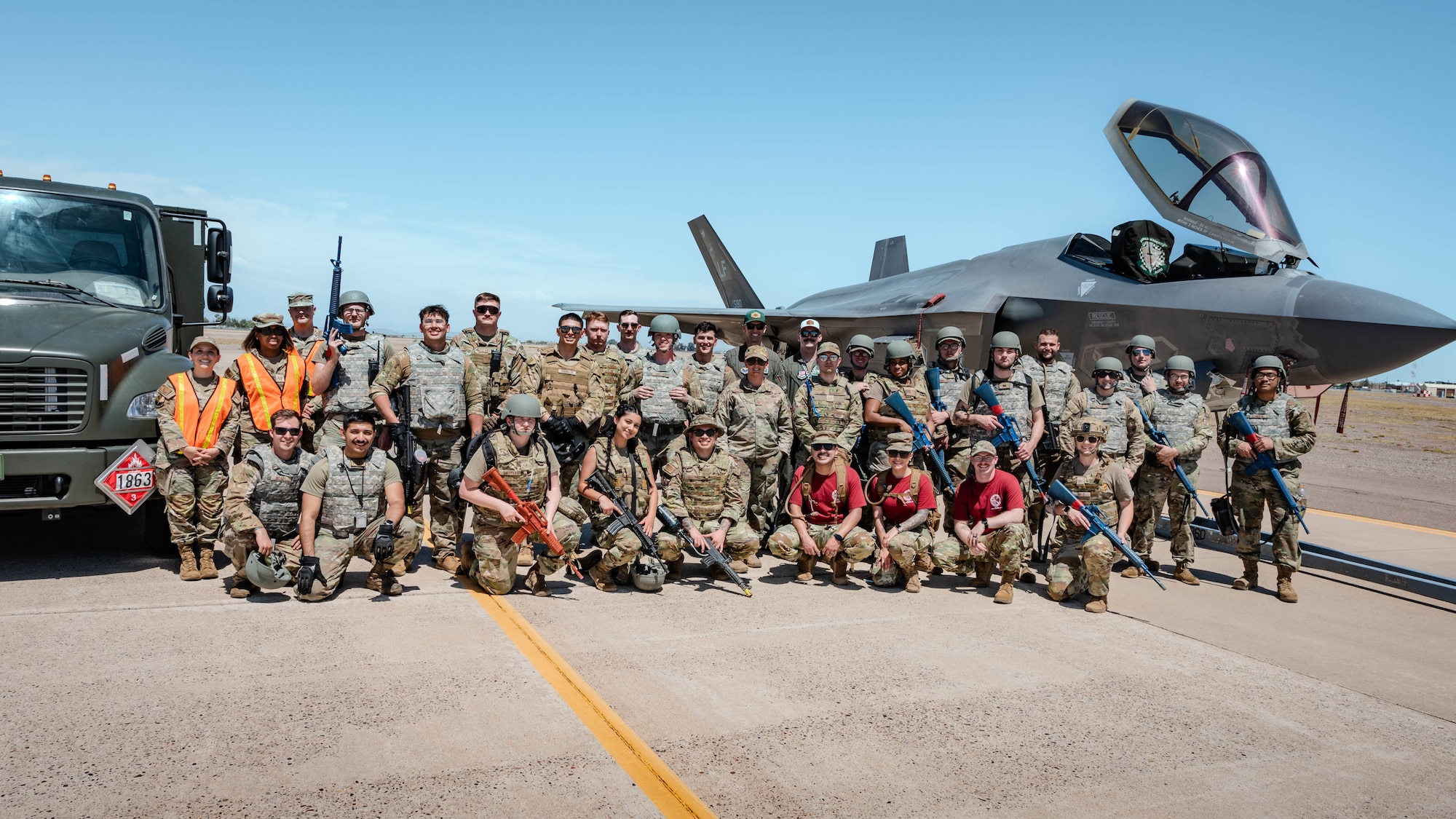 U.S. Air Force Airmen assigned to the 56th Fighter Squadron pose for a photo with a fueling truck and F-35A Lightning II