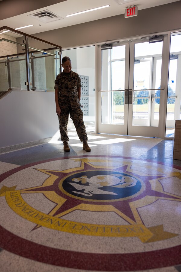 U.S. Marine Corps Brig. Gen. Maura M. Hennigan, commanding general, 2nd Marine Logistics Group (MLG), observes a crest painted on the floor during a tour of the future 2nd MLG Headquarters building on Marine Corps Base (MCB) Camp Lejeune, North Carolina, Sept. 18, 2024. Construction of the 2nd MLG Headquarters building is the result of a comprehensive infrastructure reset evaluation that took place in 2017. The new headquarters will encompass nearly 36,000 square feet and provide administrative and support functions necessary to provide combat logistics operations in support of II Marine Expeditionary Force and is expected to be completed in early 2025. (U.S. Marine Corps photo by Cpl. Loriann Dauscher)
