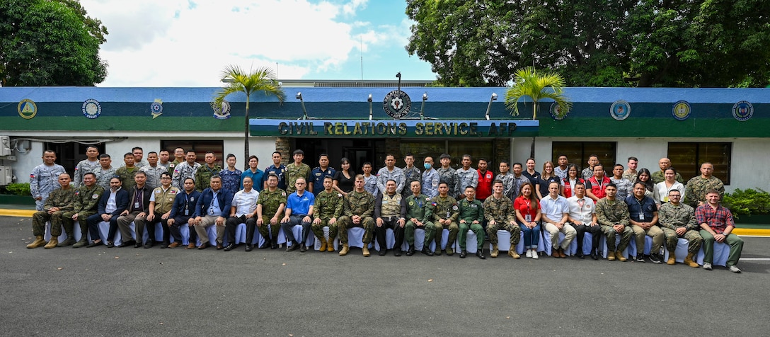 Armed Forces of the Philippines, U.S. Marines, and Japan Self-Defense Forces service members and U.S. government officials pose for a group photo during a Humanitarian Assistance and Disaster Relief Tabletop Exercise in support of Exercise Balikatan 25 at Camp Aguinaldo, Manila, Philippines, May 1, 2025. Balikatan is a longstanding annual exercise between the Armed Forces of the Philippines and the U.S. military designed to strengthen our ironclad alliance, improve our capable combined force and demonstrate our commitment to regional security and stability. (U.S. Air Force photo by Airman 1st Class Carson Jeney)
