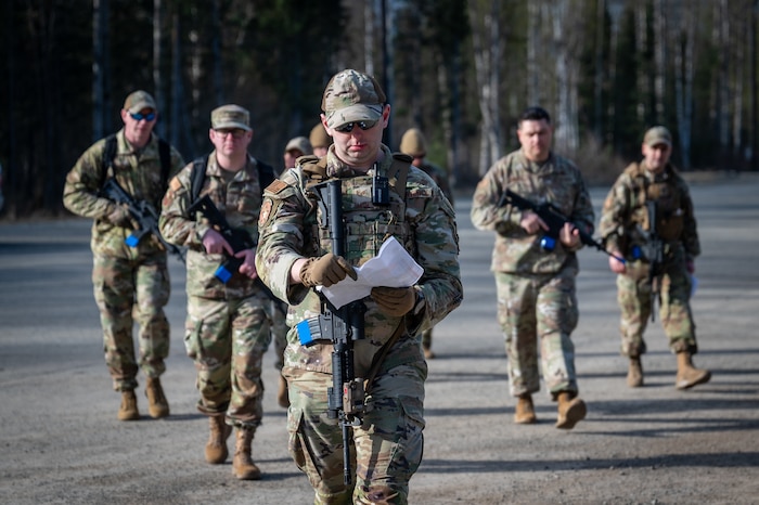 U.S. Air Force Staff Sgt. Ryan Smith, a defender assigned to the 673d Security Forces Squadron, escorts first sergeants at Camp Madbull during the first-ever Pacific Air Forces First Sergeant Readiness Summit at Joint Base Elmendorf-Richardson, Alaska, May 6. The summit brought more than 100 first sergeants from various major commands to put first sergeant responsibilities into action and improve their combat readiness. (U.S. Air Force photo by Airman 1st Class Hunter Hites)