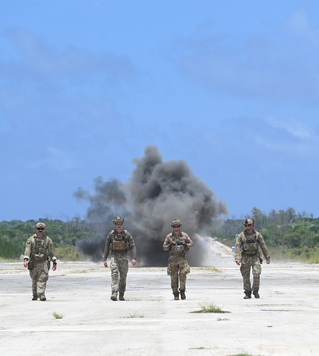 U.S. Air Force Airmen walk away from an explosive detonation during EPIC CRAB 25 Exercise at Northwest Field, Andersen Air Force Base, Guam, May 1, 2025. Explosive Ordnance Disposal locates, identifies and disposes of dangerous hazardous materials, improvised explosives devices and nuclear materials etc. (U.S. Air Force photo by Airman 1st Class Adasha Williams)