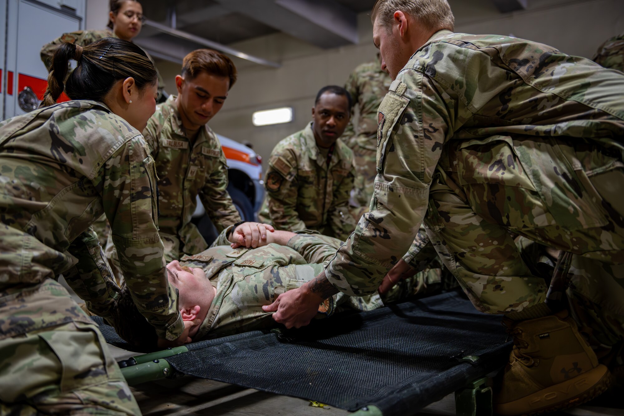 Airmen perform stretcher transfer.