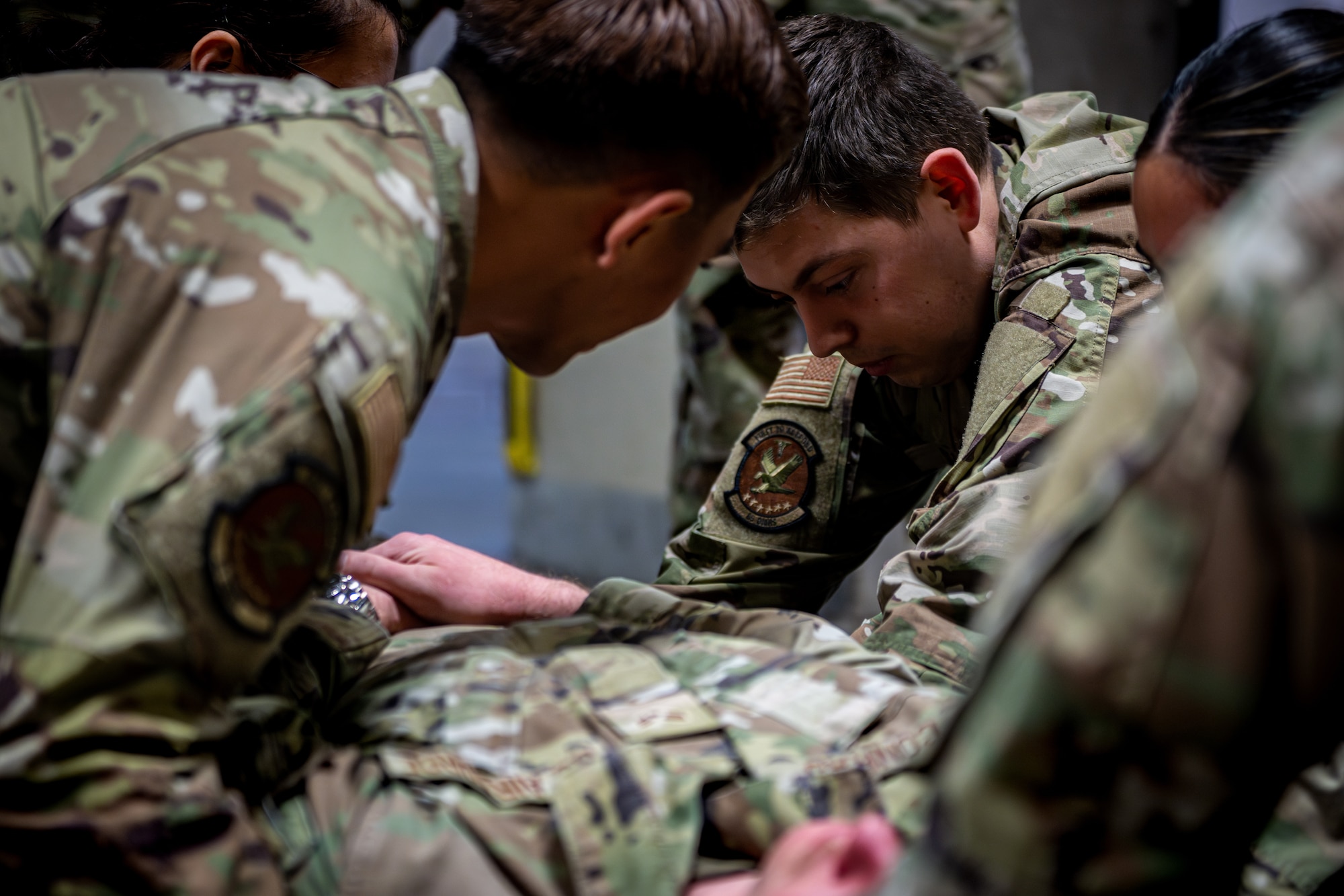 Airmen perform stretcher transfer.