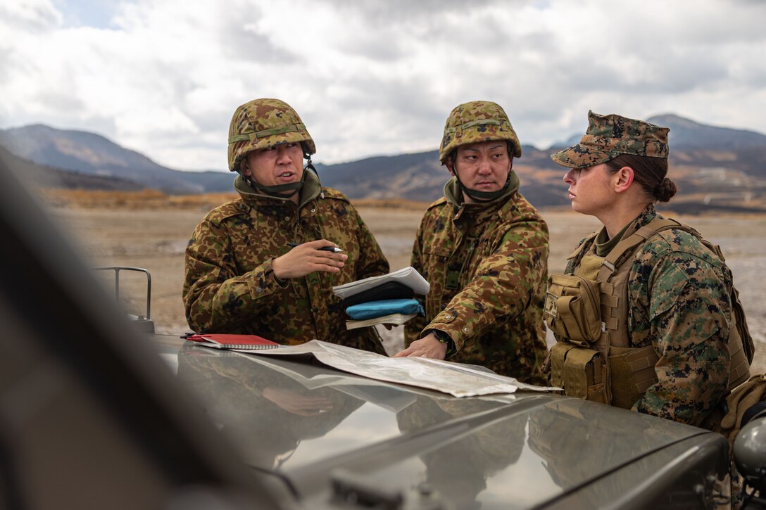 U.S. Marine Corps 2nd Lt. Sarah Euyoque, right, discusses the capabilities of a Tactical Resupply Unmanned Aircraft System with members of the Japanese Ground Self-Defense Force during Artillery Relocation Training Program 24.4 at Hijudai Maneuver Area, Oita, Japan, Feb. 26, 2025. ARTP is an annual training exercise held to strengthen the defense of Japan and the U.S. Japan Alliances as the cornerstone of peace and security in the Indo-Pacific region. The skills developed at ARTP increase the proficiency and readiness of the only permanently forward-deployed artillery unit in the Marine Corps, enabling them to provide indirect fires. Euyoque, a native of California, is a logistics officer 12th Littoral Logistics Battalion, 12th Marine Littoral Regiment, 3d Marine Division. (U.S. Marine Corps photo by Cpl. Shayla Kuhn)