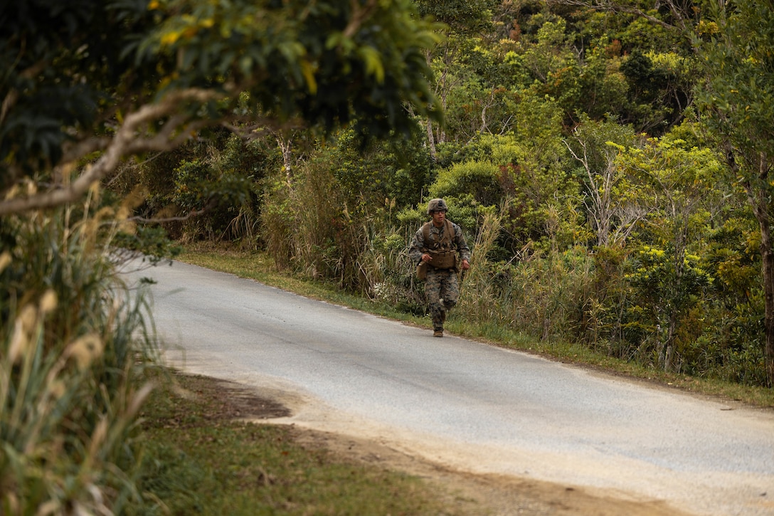 U.S. Marine Corps Cpl. Daniel VillegasPerez runs during a jungle endurance test at the Jungle Warfare Training Center on Camp Gonsalves, Okinawa, Japan, March 18, 2025. The endurance test, consisting of a ruck run, maximum pull-ups, and overhead presses, marked the start of the Basic Jungle Skills Course. The course prepares Marines to operate with confidence and effectiveness in an austere jungle environment. VillegasPerez, a native of California, is a rifleman with 12th Littoral Combat Team, 12th Marine Littoral Regiment, 3d Marine Division. (U.S. Marine Corps photo by Staff Sgt. JVonnta Taylor)