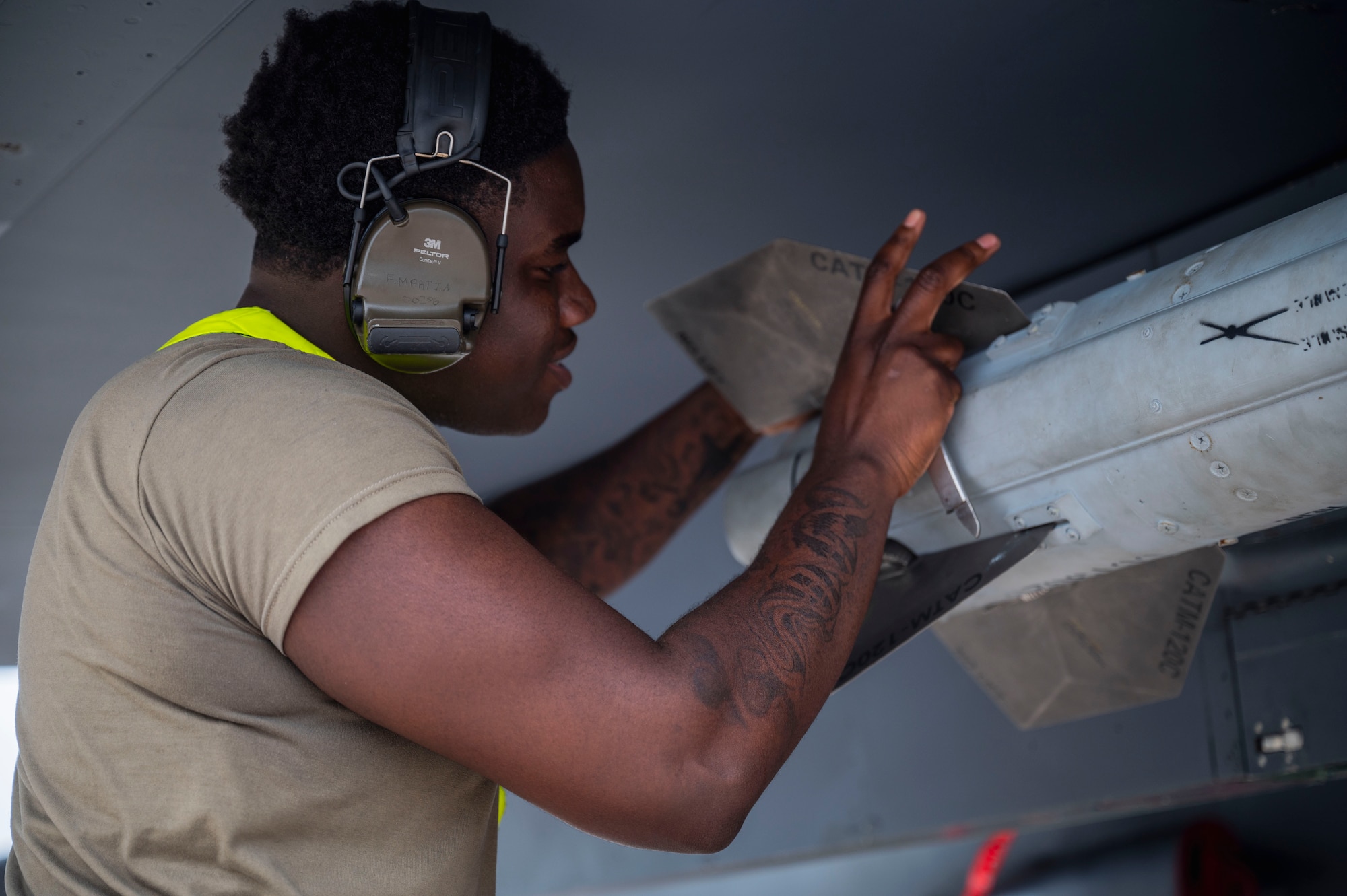 U.S. Air Force Senior Airman Fredarious Martin, 336th Fighter Generation Squadron load crew member, affixes a tail fin to a munition