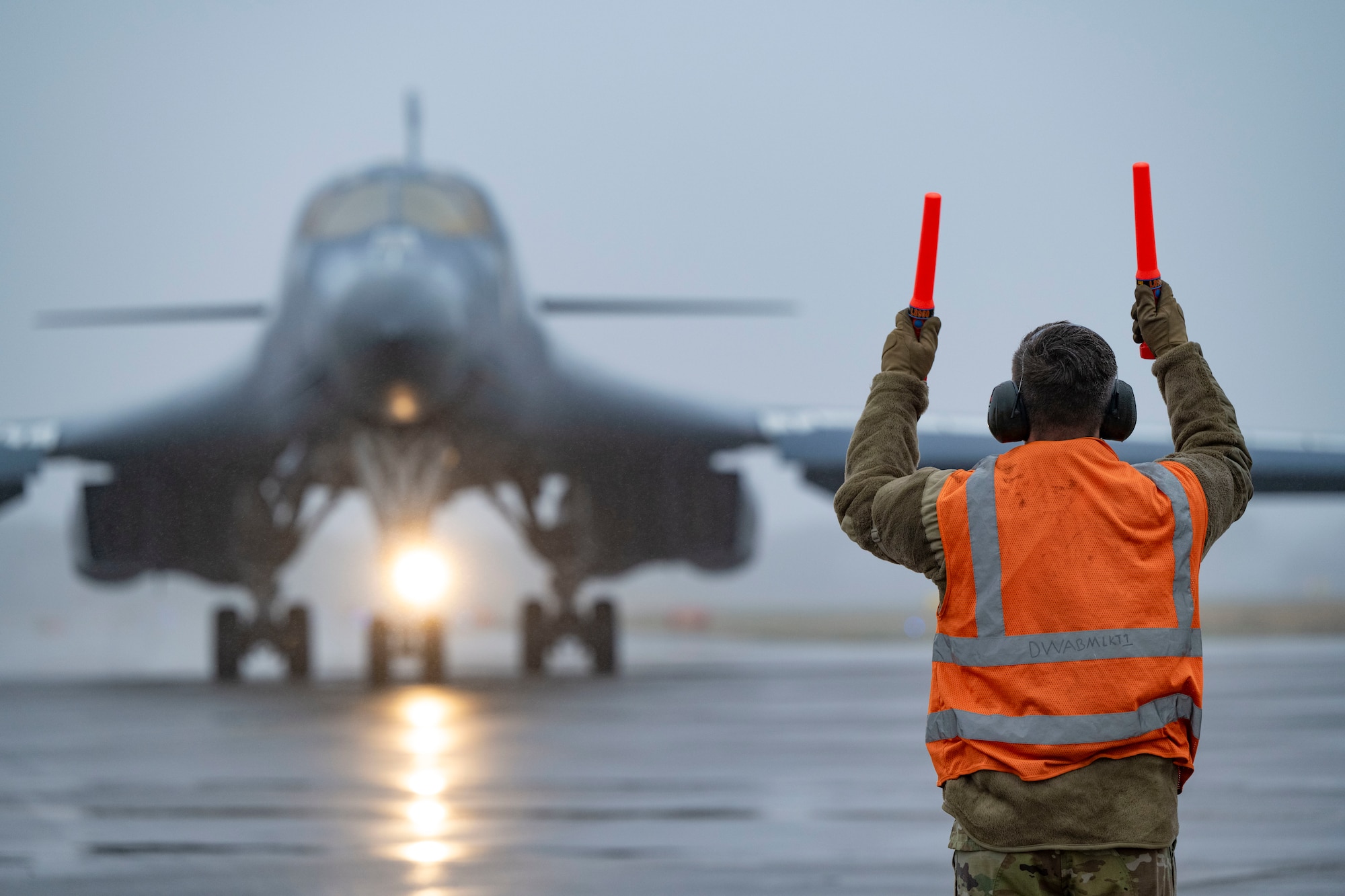 Airman directing B-1B