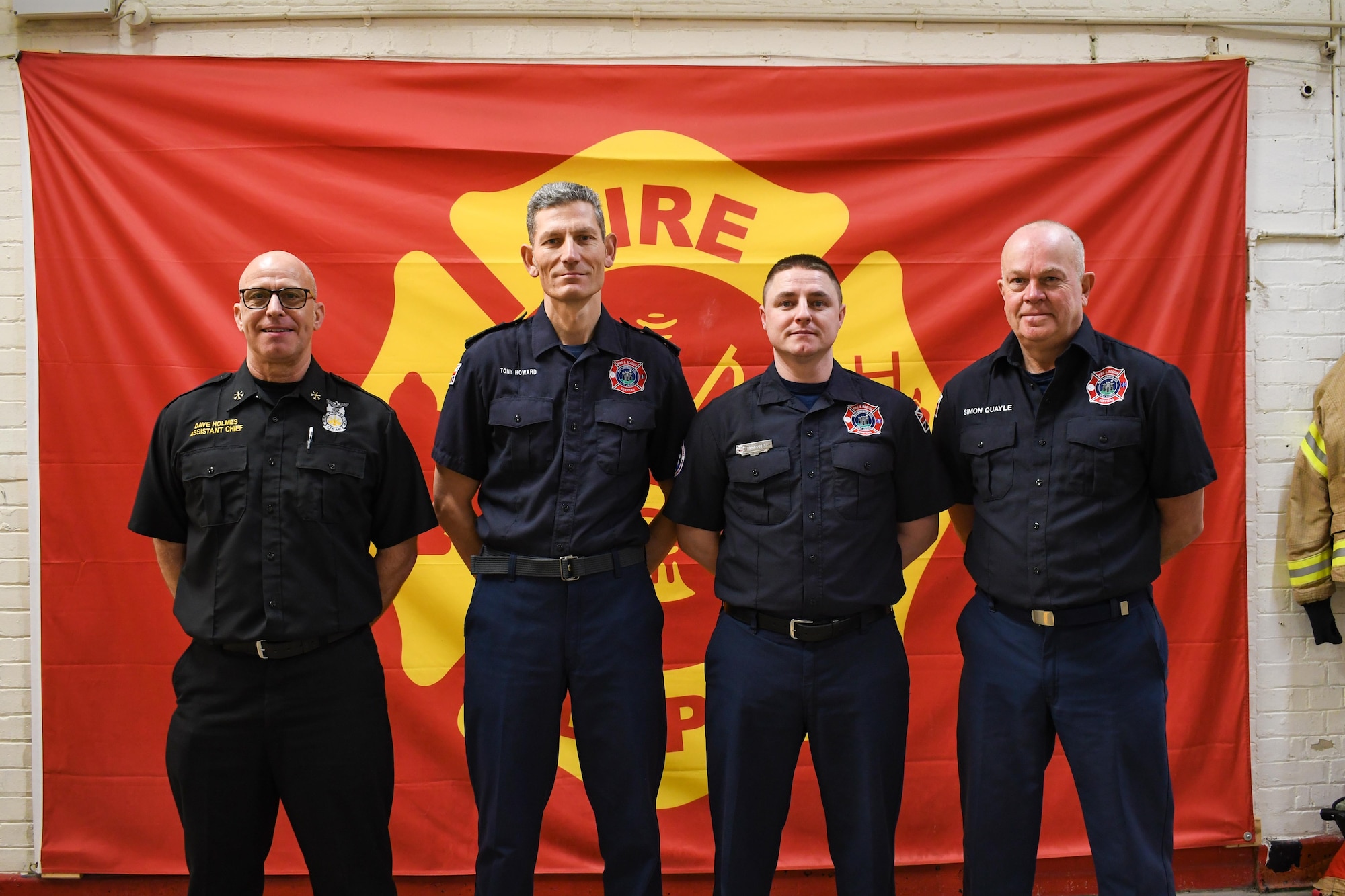 Members of the 421st Civil Engineer Flight (CEF) Fire and Emergency Services (F&ES) Blue Watch pose for a group photo