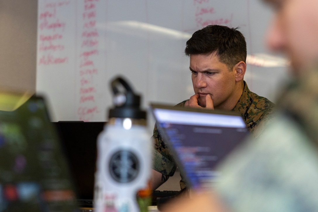U.S. Marine Corps Maj. Ben Opel, cyberspace officer, Defensive Cyberspace Operations Internal Defensive Measures, acts as the oppositional force during exercise Southern Defender 25 in Augusta, Georgia, May 6, 2025. The oppositional force emulates adversary tactics, firing scenario-based challenges at 28 teams in 15 locations consisting of 20 participating countries in real time. (U.S. Marine Corps photo by Sgt. Samuel Qin)