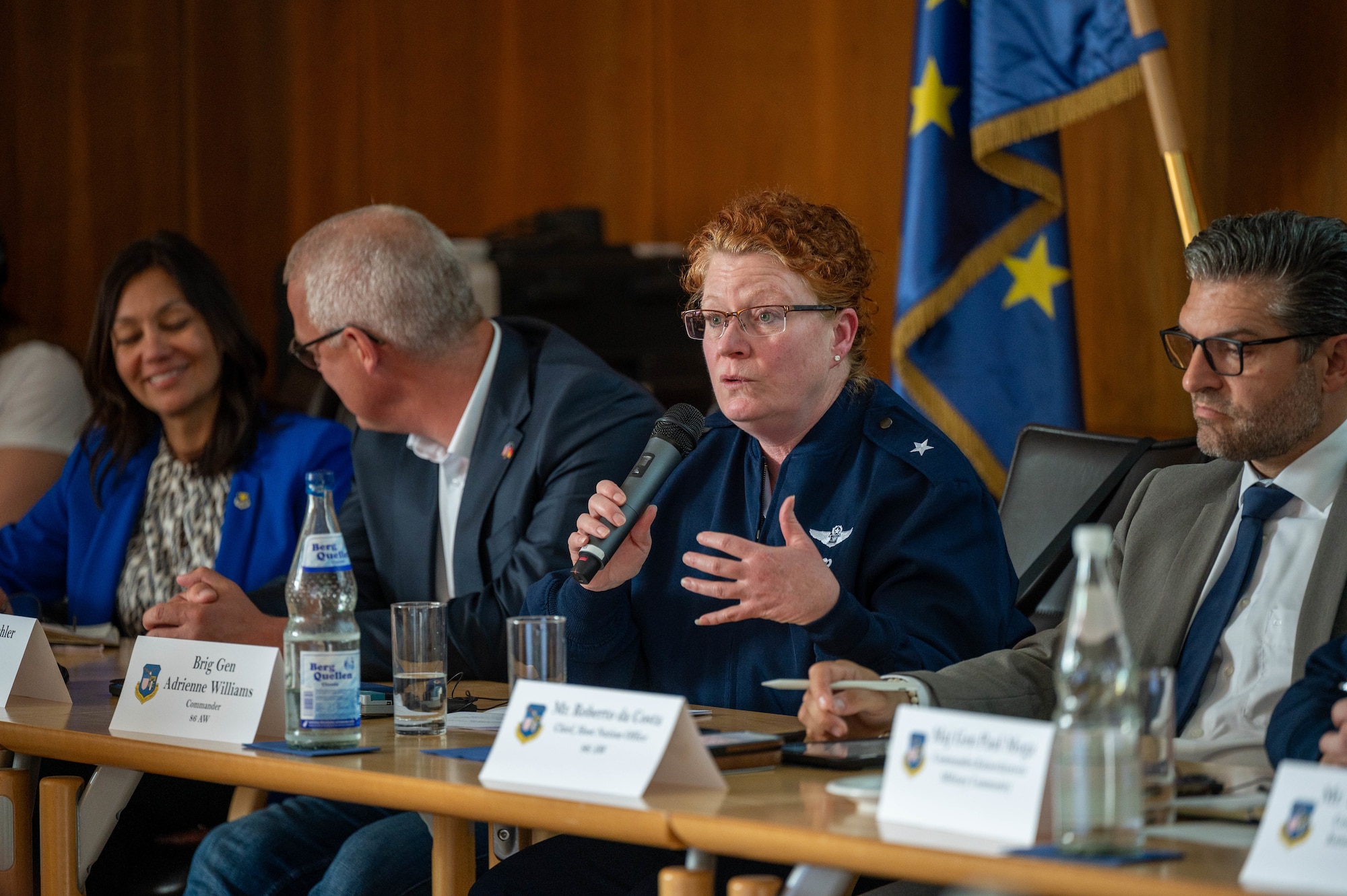 A woman speaks at a forum