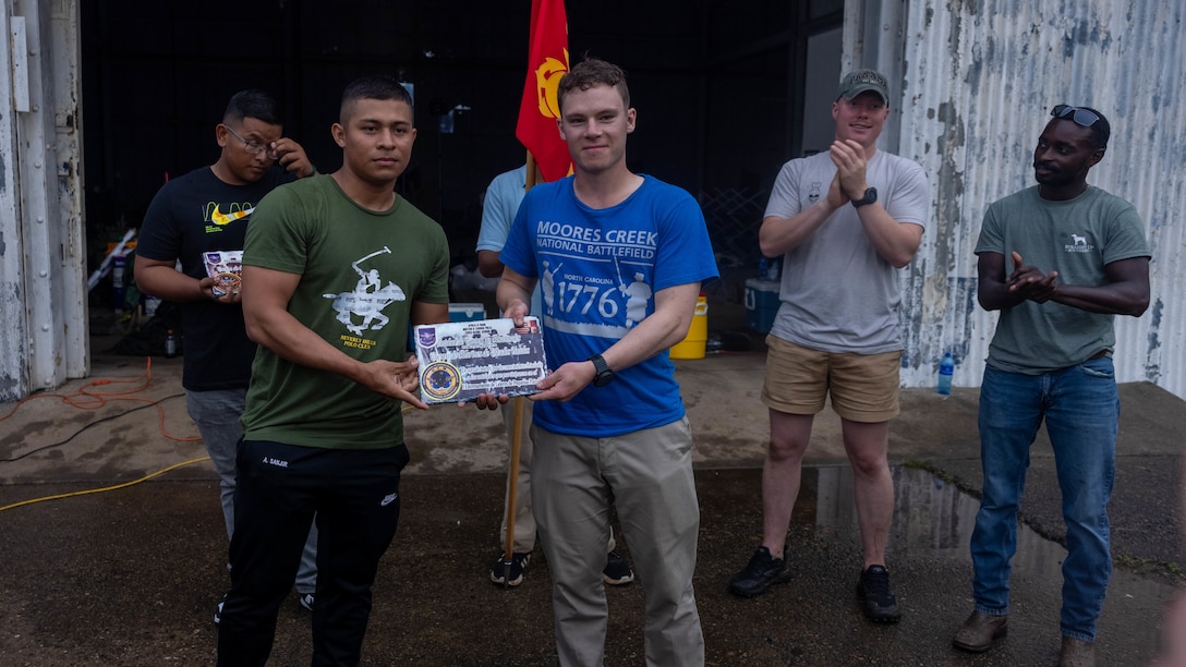 U.S. Marine Corps Sgt. Jackson Lake, a Newton, Massachusetts native and squad leader with 1st Battalion, 8th Marine Regiment, 2d Marine Division receives a plaque from a Panamanian security force member to commemorate training together in Rodman, Panama, May 2, 2025. U.S. Southern Command is focused on increasing partner nation capacity and interoperability in the region and reflects the United States’ enduring promise of friendship, partnership, and solidarity with the Panamanian people. (U.S. Marine Corps photo by Lance Cpl. Francis Hrosar)