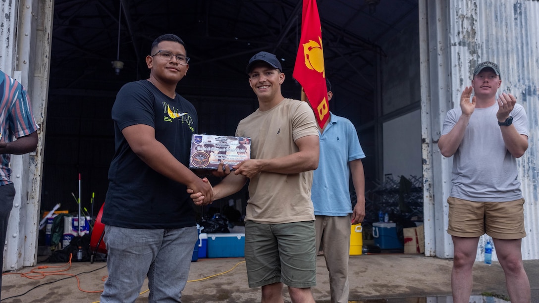 U.S. Marine Corps Sgt. Jordan Krische, a Lehigh Township, Pennsylvania native and squad leader with 1st Battalion, 8th Marine Regiment, 2d Marine Division receives a plaque from a Panamanian security force member to commemorate training together in Rodman, Panama, May 2, 2025. U.S. Southern Command is focused on increasing partner nation capacity and interoperability in the region and reflects the United States’ enduring promise of friendship, partnership, and solidarity with the Panamanian people. (U.S. Marine Corps photo by Lance Cpl. Francis Hrosar)