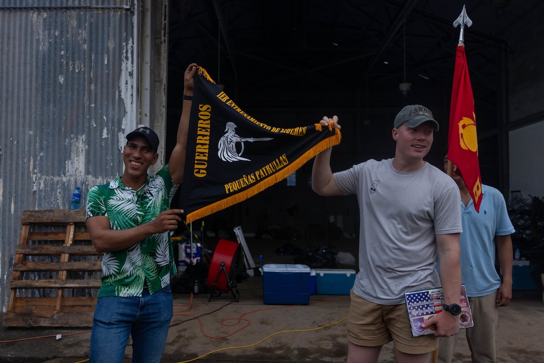U.S. Marine Corps 1st Lt. Joshua Tiren, a Germantown, Maryland native and platoon commander with 1st Battalion, 8th Marine Regiment, 2d Marine Division receives a flag from a Panamanian security force member to commemorate training together in Rodman, Panama, May 2, 2025. U.S. Southern Command is focused on increasing partner nation capacity and interoperability in the region and reflects the United States’ enduring promise of friendship, partnership, and solidarity with the Panamanian people. (U.S. Marine Corps photo by Lance Cpl. Francis Hrosar)
