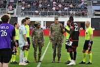 From right, U.S. Air Force Col. Ryan A.F. Crowley, commander of Joint Base Anacostia-Bolling and the 11th Wing, and Chief Master Sgt. Catrell Wilson, senior enlisted leader of the 11th Operations Group, participate in the opening ceremony coin toss for a DC United Football club match at Audi Field in Washington D.C., May 3, 2025. DC United invited JBAB leadership to conduct the ceremonial coin flip that decided which team will have the first kick, and military members to participate in their Military Appreciation Night. (U.S. Air Force photo by Staff Sgt. Brandon Schneider)
