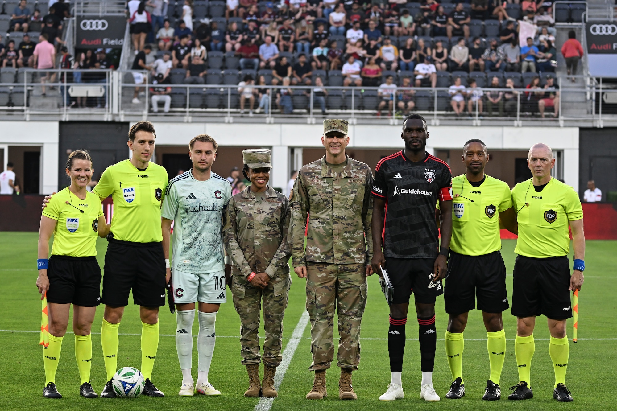 U.S. Air Force Col. Ryan A.F. Crowley, commander of Joint Base Anacostia-Bolling and the 11th Wing, and Chief Master Sgt. Catrell Wilson, senior enlisted leader of the 11th Operations Group, stand with team captains and referee officials after the opening ceremony coin toss for the DC United Football club match at Audi Field in Washington D.C., May 3, 2025. DC United invited members from JBAB to honor our nation’s past and current military members during their military appreciation night. (U.S. Air Force photo by Staff Sgt. Brandon Schneider)