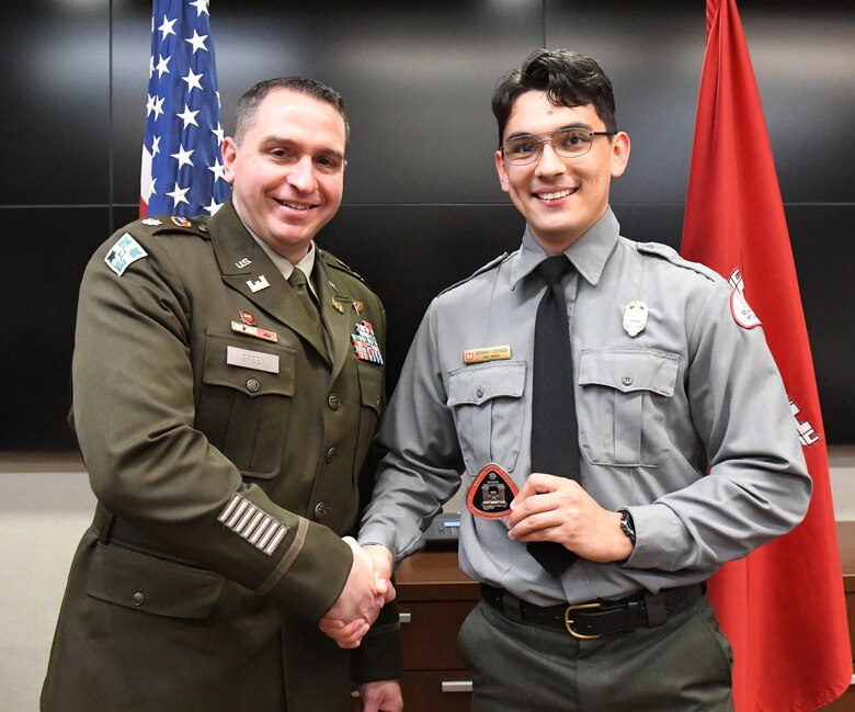 Lt. Col. Robert Green, U.S. Army Corps of Engineers Nashville District commander, left, presents a commander’s coin to Park Ranger Giovanny Espinoza of Old Hickory Lake May 5, 2025, in Nashville, Tenn. Espinoza was recognized for developing a bilingual public service announcement that promoted water safety and life jacket use at J. Percy Priest Lake. (USACE Photo by Noe Gonzalez)