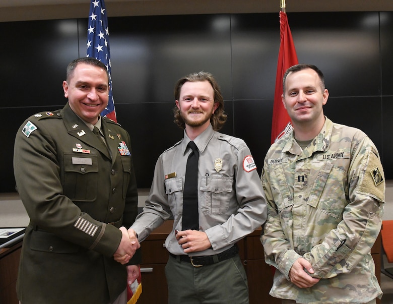 Lt. Col. Robert Green, U.S. Army Corps of Engineers Nashville District commander, left, presents a commander’s coin to Conservation Biologist Mitchell Crockarell of Cheatham Lake as Capt. Matthew Gursky, right, looks on May 5, 2025, in Nashville, Tenn. Crockarell was recognized for his work with the Visitation Estimation Reporting System Coach Assist and Train Team, supporting accurate visitor data reporting across Corps sites. (USACE Photo by Noe Gonzalez)