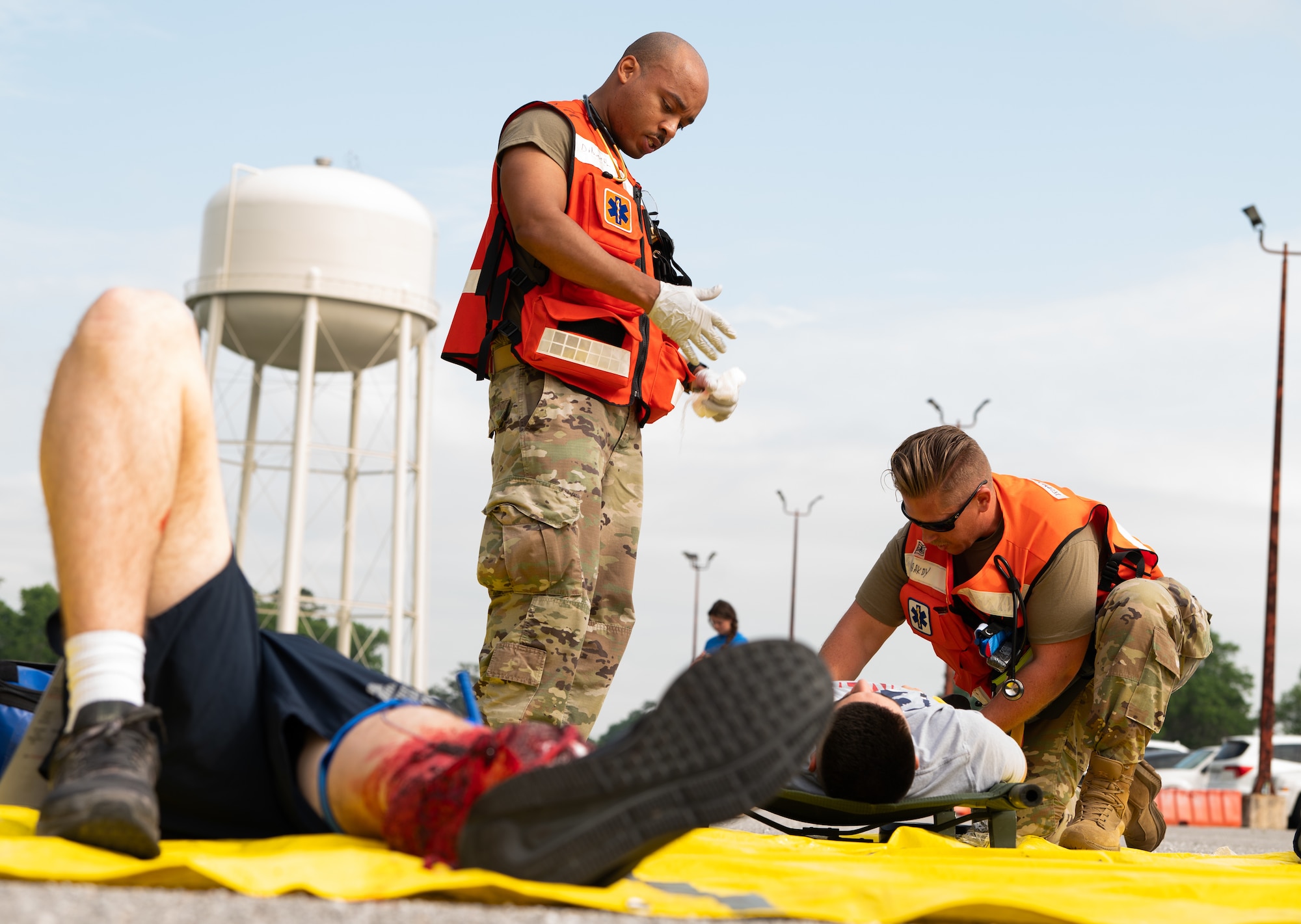 Two medical personell check the vitals of patients during a medical exercise.