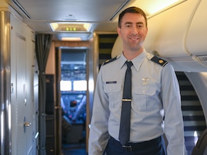 U.S. Air Force Maj. Adam Ferek, a pilot with the 201st Airlift Squadron, 113th Wing, District of Columbia Air National Guard, poses in the aisle of a C-40 aircraft on Joint Base Andrews, Maryland Jan. 9, 2025.  Ferek was the pilot and mission commander for the Congressional Delegation flight for the funeral services of Pope Francis. (U.S. Air National Guard photo by Tech. Sgt. Andrew Enriquez)
