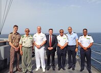 Capt. Colin Price, commanding officer of the Blue Ridge-class command and control ship USS Mount Whitney (LCC 20), leads U.S. and Mauritanian military and civilian officials on a tour of the ship while anchored near Nouakchott, Mauritania, May 8, 2025.