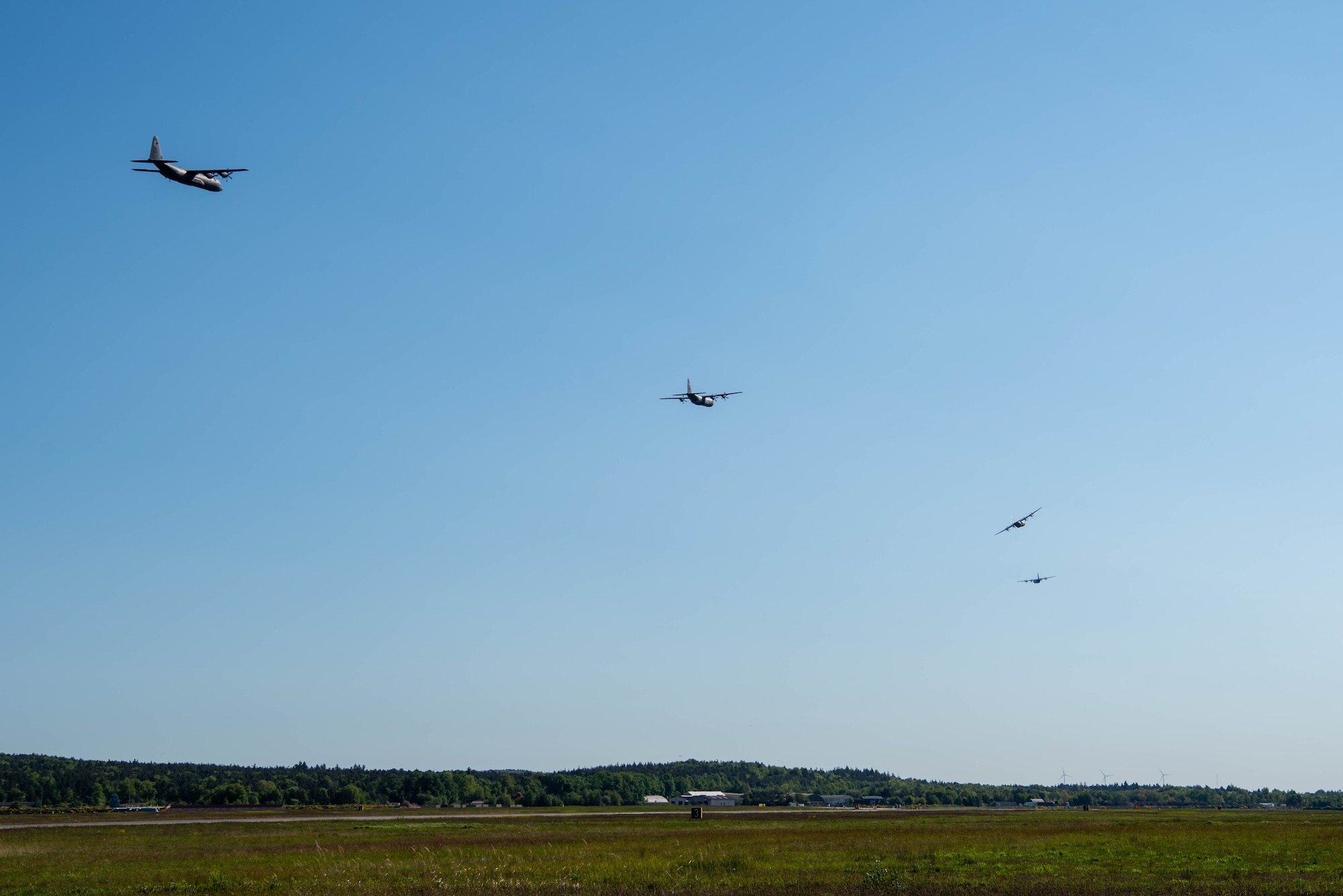 A formation of C-130J Super Hercules aircraft perform a flyover