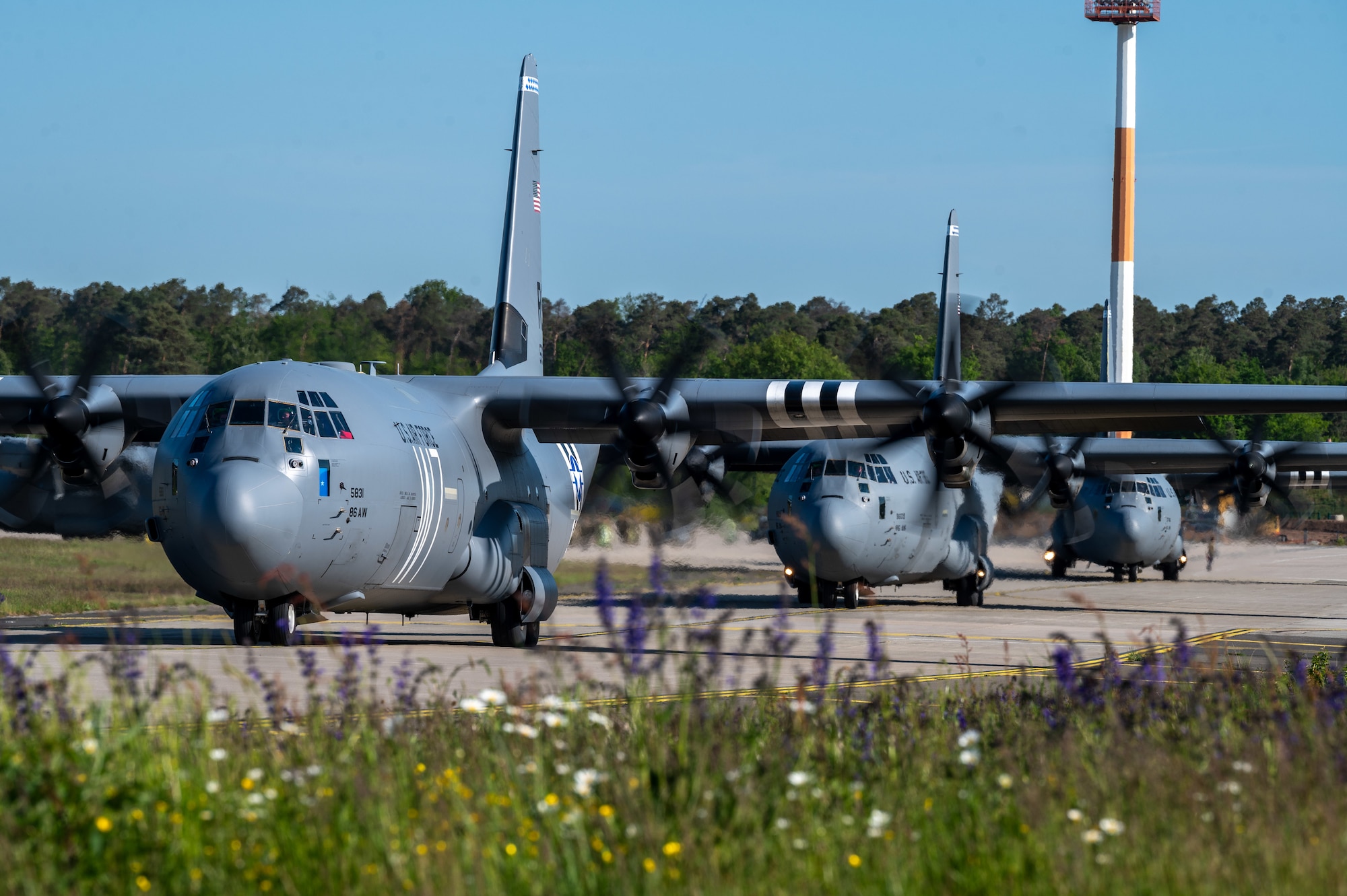 Three C-130J Super Hercules aircraft participate in an elephant walk