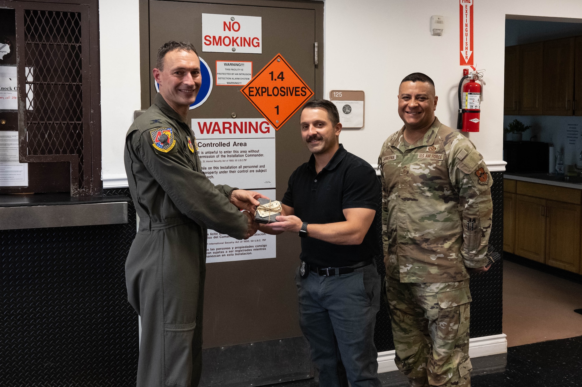 U.S. Air Force Col. Tyler Ellison, 47th Flying Training Wing commander, and Chief Master Sgt. Lester Largaespada, 47th FTW command chief, present a first quarter award at Laughlin Air Force Base, May 2, 2025. The quarterly awards ceremony honored Airmen and civilians who demonstrated exceptional performance, leadership, and mission impact across the wing. (U.S. Air Force photo by Airman 1st lass Harrison Sullivan)