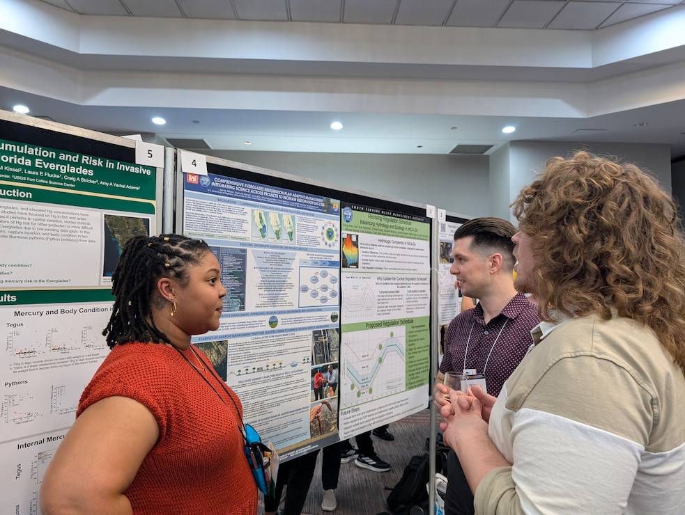 RECOVER team members, Tasso Cocoves and Kiah Williams, discuss Asian Swamp Eel adaptive management at the Greater Everglades Ecosystem Restoration Conference.