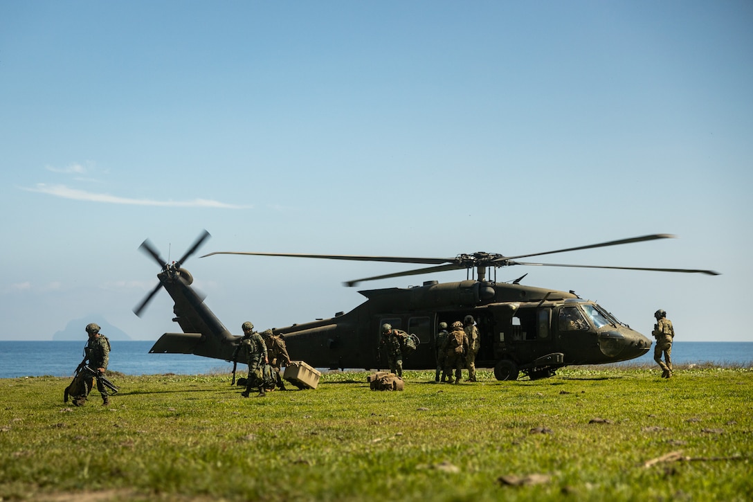 U.S. Marines with 3d Marine Division and Philippine Marines with Marine Battalion Landing Team 10, unload from a U.S. Army UH-60 Black Hawk with 25th Combat Aviation Brigade, 25th Infantry Division, while participating in the Maritime Key Terrain Security Operations event during Exercise Balikatan 25 in the Batanes island chain, Philippines, April 24, 2025. Balikatan is a longstanding annual exercise between the Armed Forces of the Philippines and U.S. military designed to strengthen our ironclad alliance, improve our capable combined force, and demonstrate our commitment to regional security and stability.