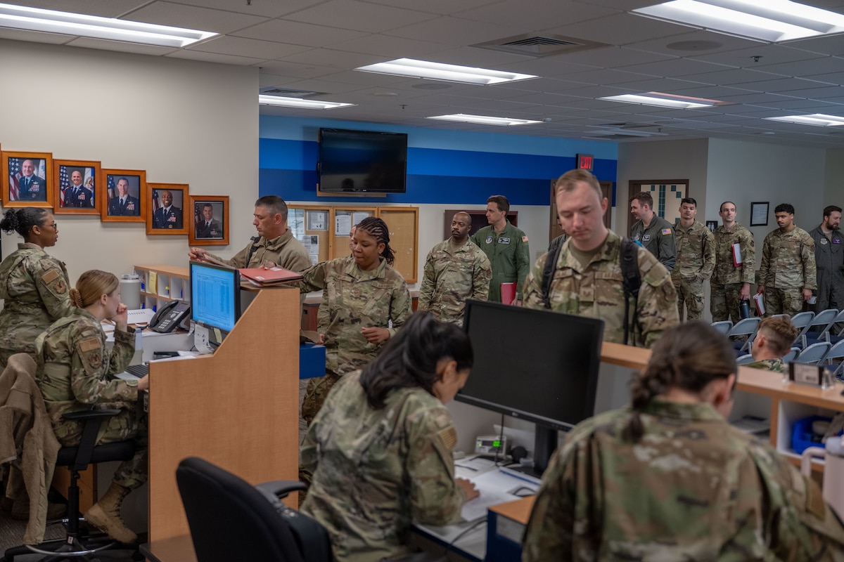 Team McConnell Airmen provide documentation and gear weight to in-process the passenger terminal during Exercise Lethal Stack at McConnell Air Force Base, Kansas, May 5, 2025. Lethal Stack is a multi-day exercise that puts emphasis on speed and coordination while under pressure. (U.S. Air Force photo by Airman 1st Class Paula Arce)