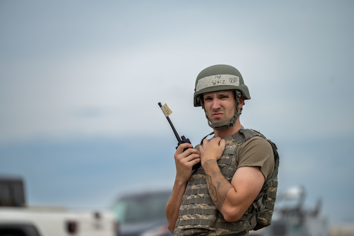 Tech. Sgt. Jonathan Wurz, 931st Maintenance Squadron aerospace maintenance technician,  uses a two-way radio during Exercise Lethal Stack at McConnell Air Force Base, Kansas, May 6, 2025. Lethal Stack simulates a high-threat environment where McConnell Airmen prove they can operate and sustain operations. (U.S. Air Force photo by Airman 1st Class Paula Arce)