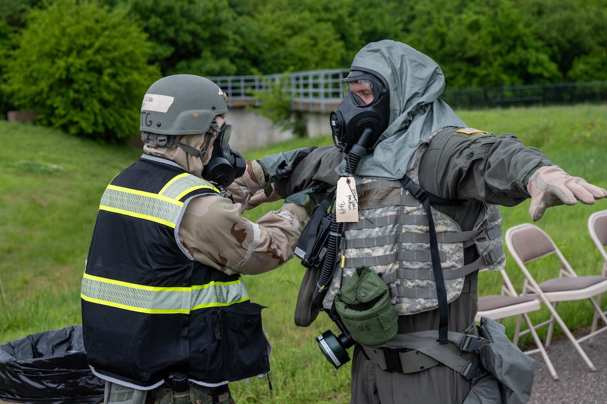 Senior Airman Blake Ellison, 22nd Operations Support Squadron aircrew flight equipment specialist, pats down Capt. Paxton Petitpas, 349th Air Refueling Squadron chief of tactics, during Exercise Lethal Stack at McConnell Air Force Base, Kansas, May 7, 2025. A pat down with decontamination gloves is the first step of the chemical decontamination process. (U.S. Air Force photo by Airman 1st Class Patrick O’Neill)