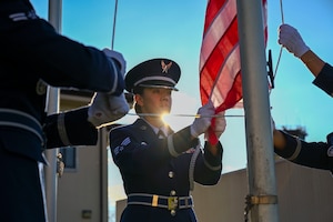 Honor Guardsman lowering flag