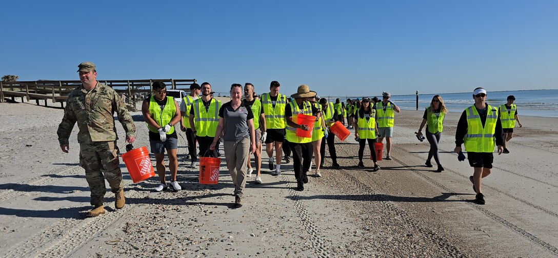 U.S. Army Corps of Engineers, Jacksonville District Deputy Commander, Maj. Matt Westcott leads a team of volunteers from the Jacksonville Jaguars front office to plant bitter panic grass and sea oats along the Duval County Shoreline, near Hanna Park.